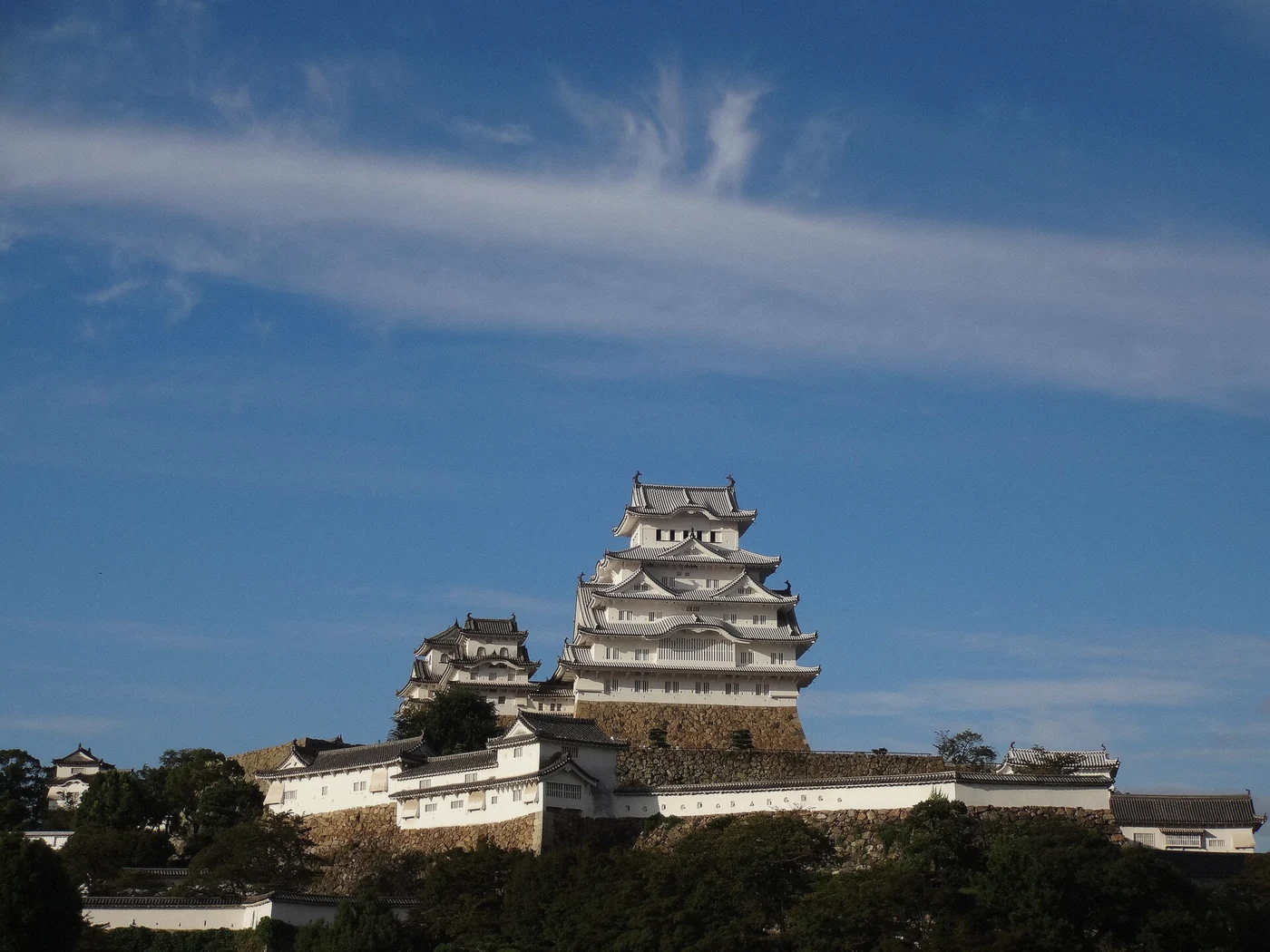 Himeji Castle in autumn colour with the keep above red maples in Japan