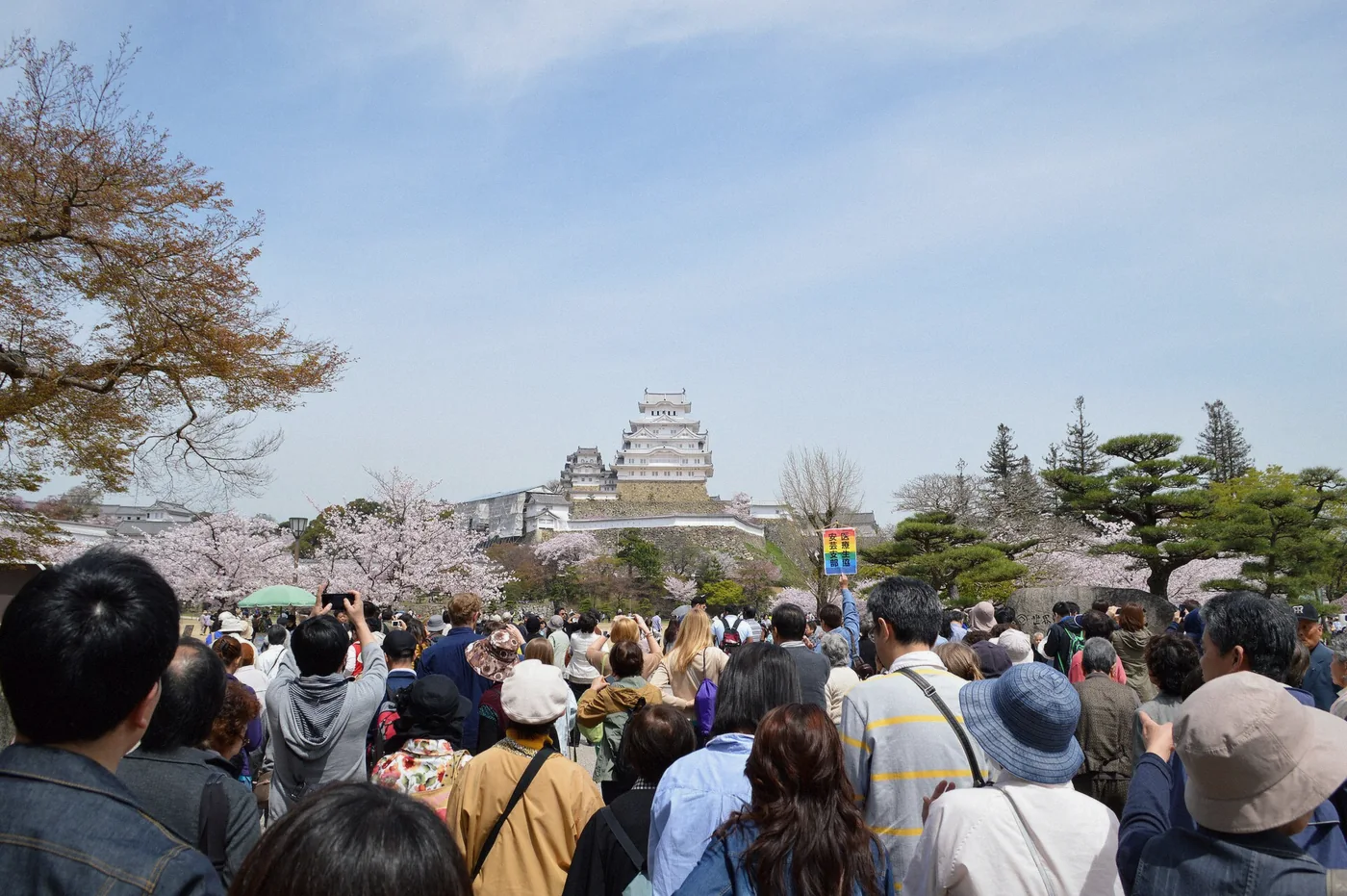 Crowds walking toward the keep of Himeji Castle on a busy visiting day in Japan