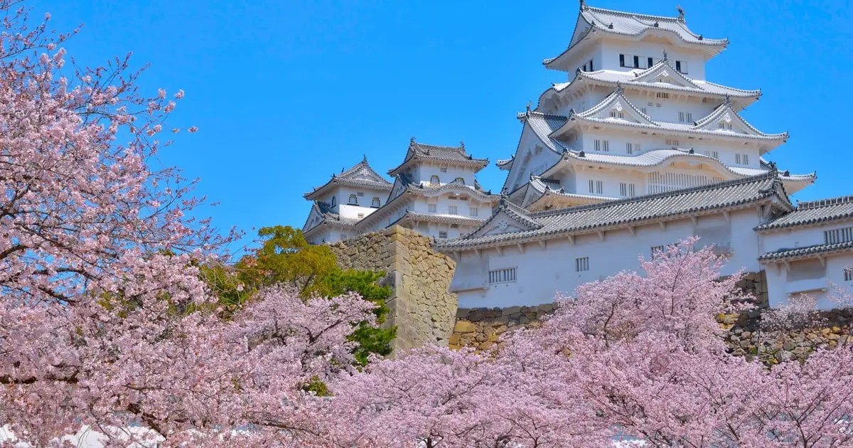 Old town lane and stone walls below Himeji Castle on the city culture walk with entry tickets in Himeji, Japan