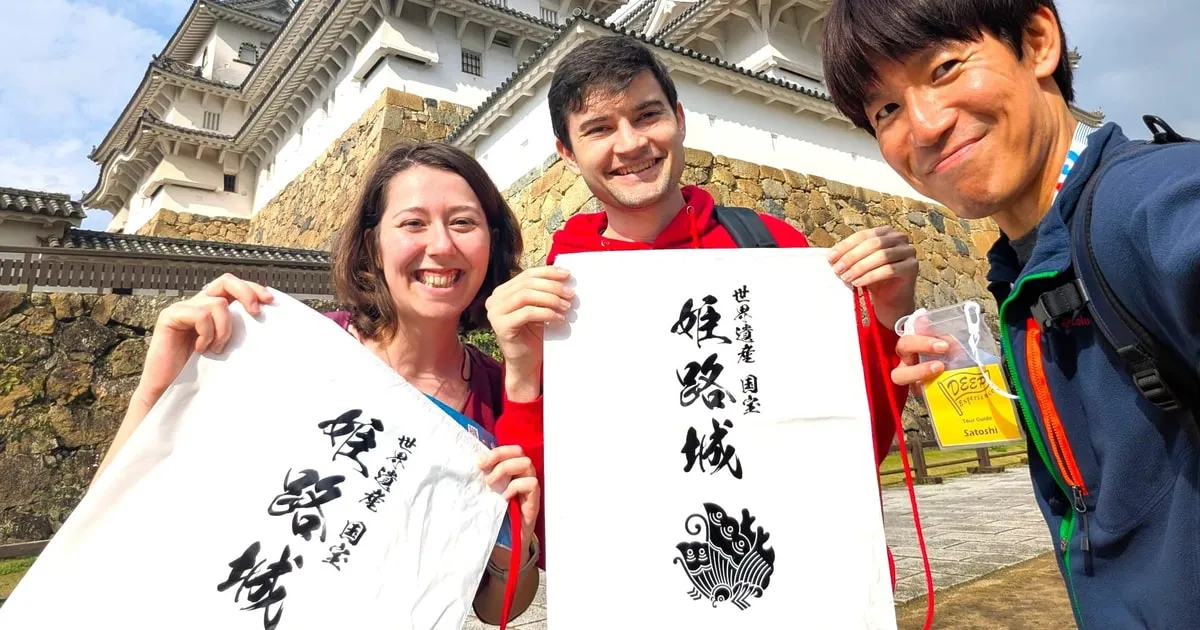 Guide and travellers at the keep entrance of Himeji Castle on a flexible guided tour with entry included in Japan